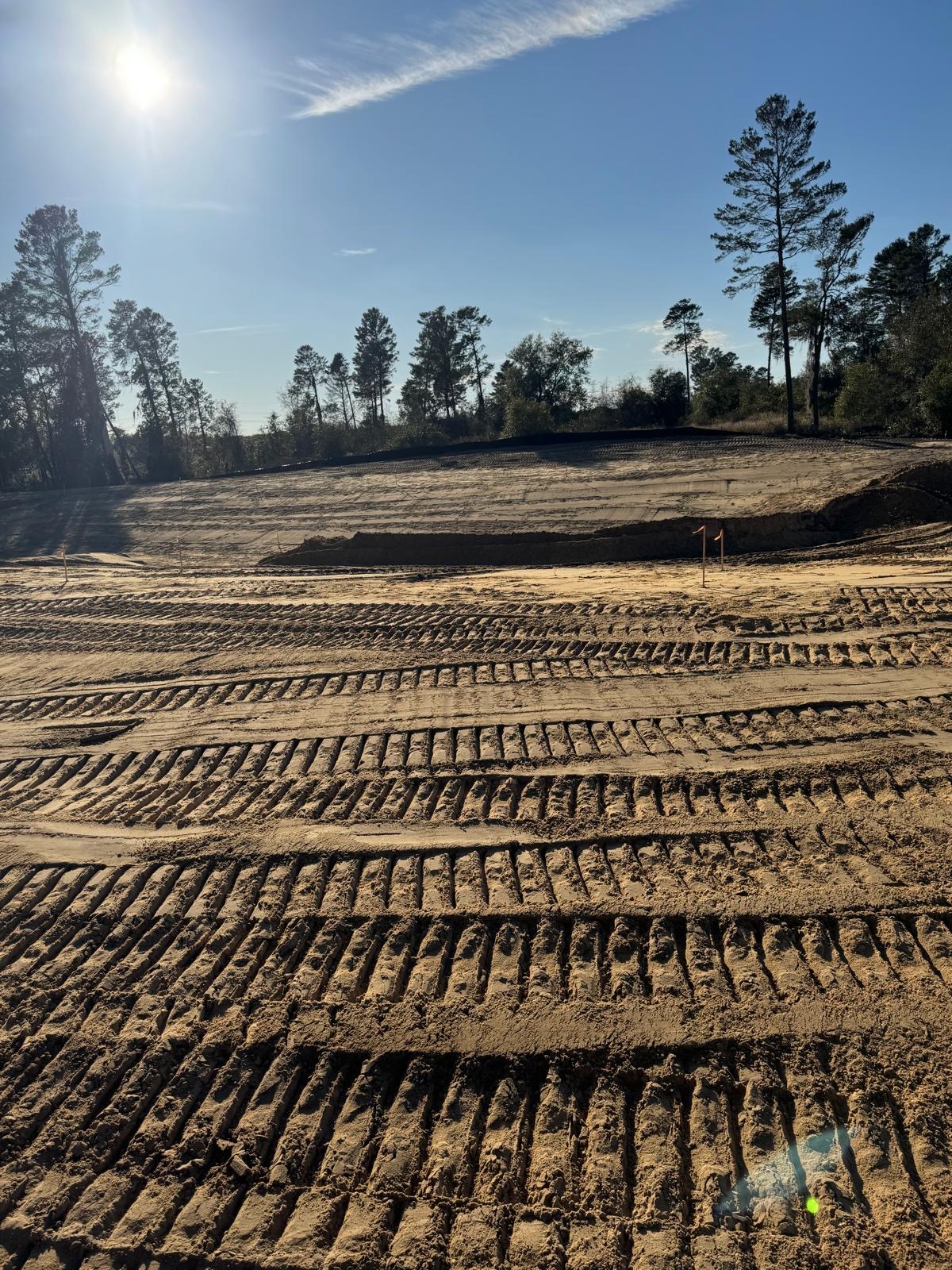 Finished sandy building pad with equipment tracks