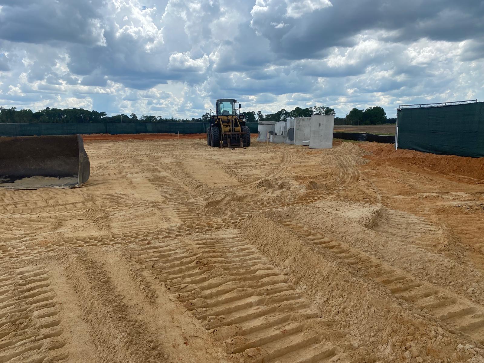 Loader on a prepared construction site with storm materials